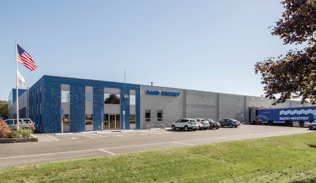 A blue building with cars parked in front of it.