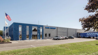 A blue building with cars parked in front of it.