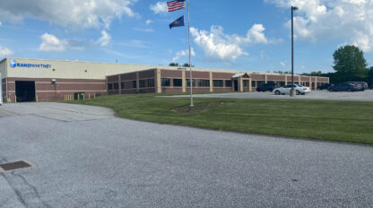 A building with an american flag in front of it.