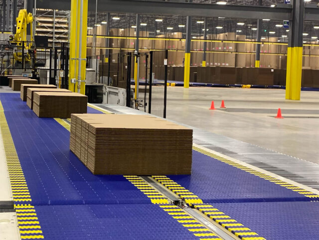 A conveyor belt in a warehouse with boxes on it.