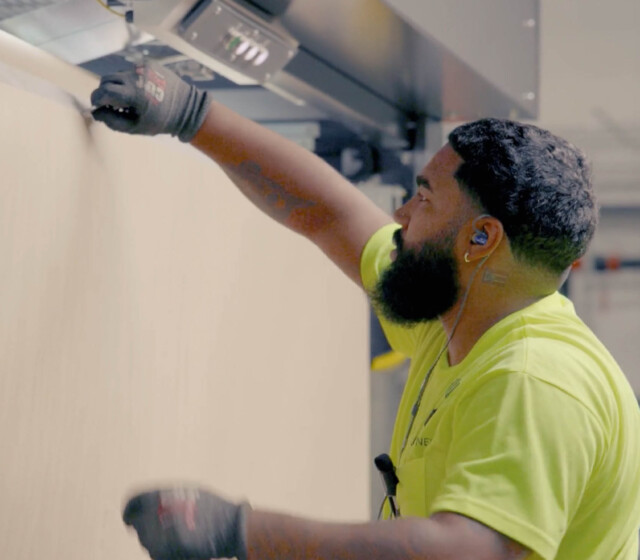 A man with a beard working on a machine.