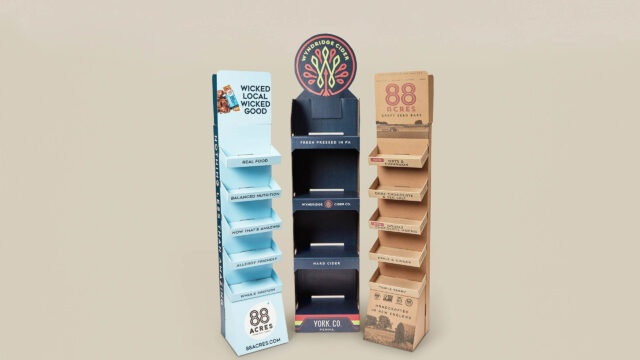 A cardboard display stand with a variety of products on it.