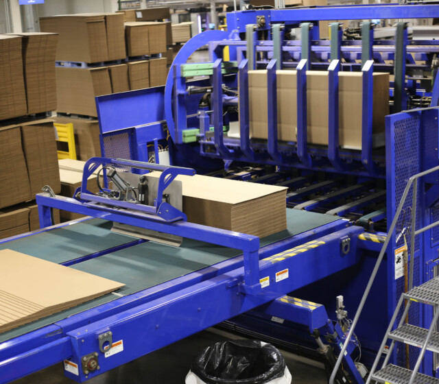 A blue machine in a warehouse.