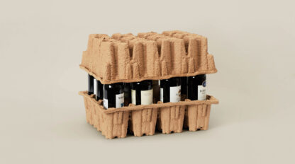 A stack of wine bottles in molded pulp packaging.