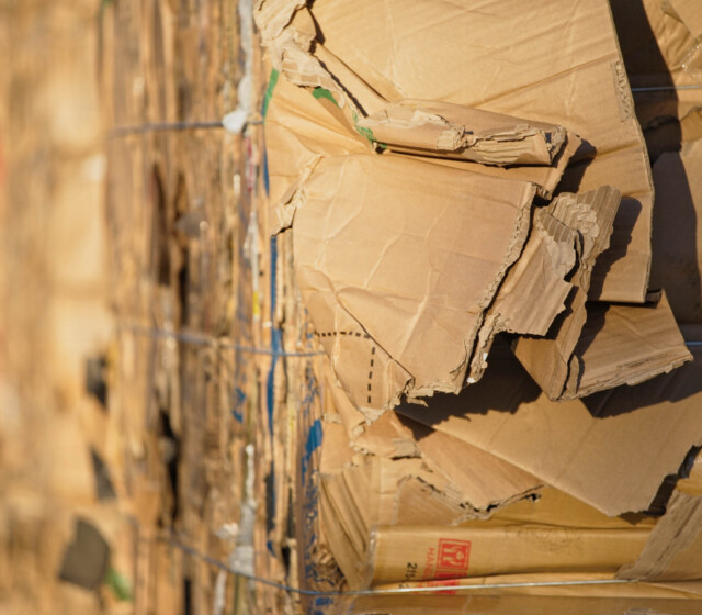A stack of recycled cardboard boxes in a warehouse.